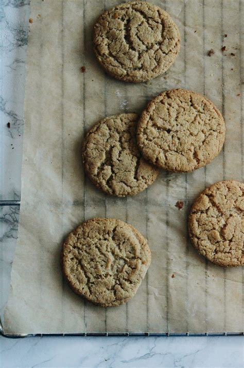 Four Cookies Sitting On Top Of A Piece Of Parchment Paper