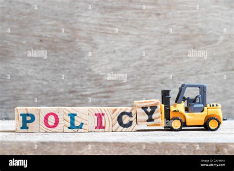 Toy Forklift Hold Letter Block Y To Complete Word Policy On Wood