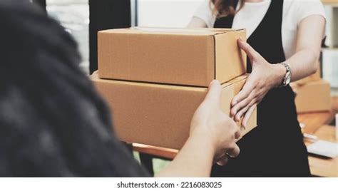 Woman Hand Accepting A Delivery Of Boxes From Deliveryman Images