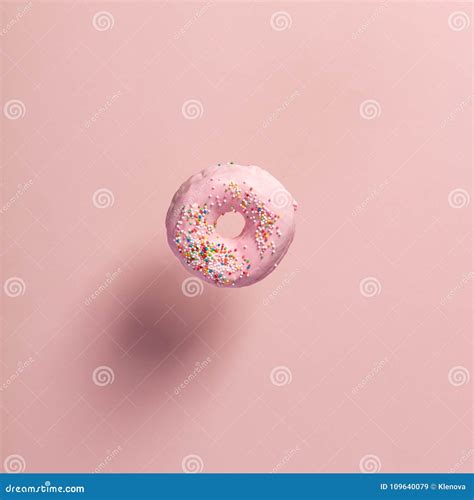 Pink Doughnut With Sprinkles Falling Or Flying In Motion Stock Image