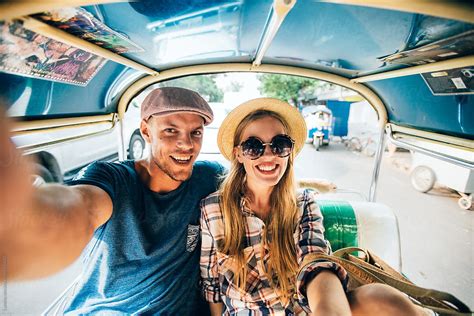 Couple Riding In A Tuk Tuk Taxi In Bangkok By Stocksy Contributor