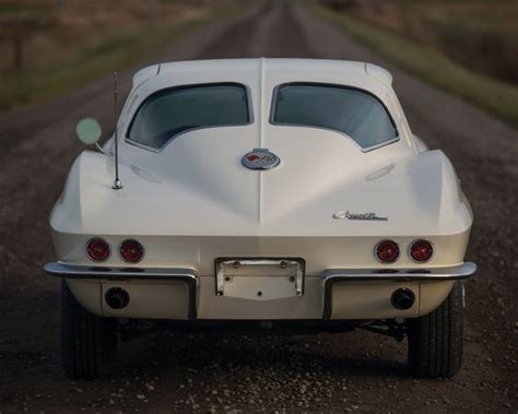 A White Car Parked On The Side Of A Dirt Road