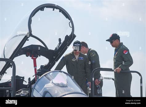 Singapore - February 16, 2016: American Pacific Air Forces soldiers checking out the cockpit of ...