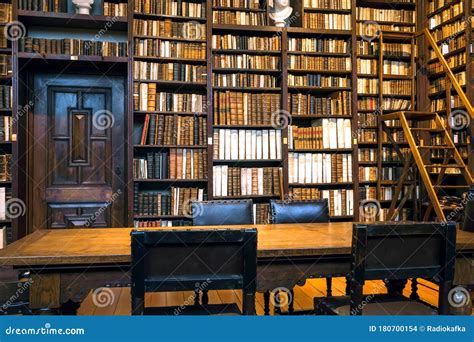Volumes Of 17th Century Books And 18th On Bookshelves Of An Old Library