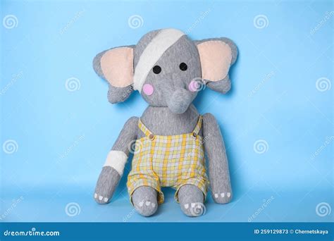 Toy Elephant With Bandages On Light Blue Background Stock Image Image