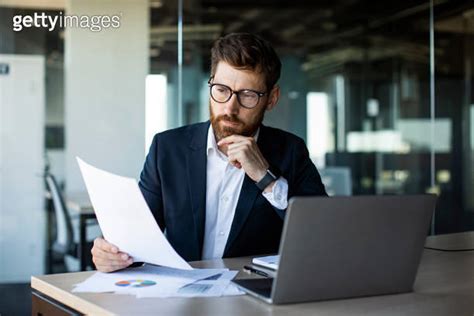 Busy Mature Businessman With Beard In Suit Working With Documents In