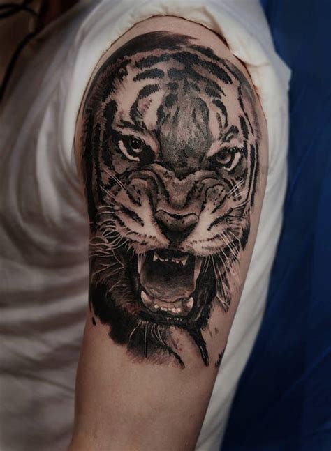 Realistic tiger tattoo on the left upper arm and