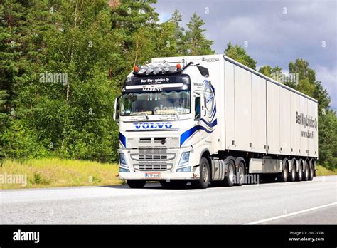 Customized White Volvo Fh Truck Pulls Tyllis Semi Trailer Along Highway