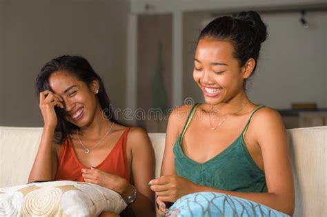 Lifestyle Portrait Of Two Young Happy And Relaxed Asian Girlfriends