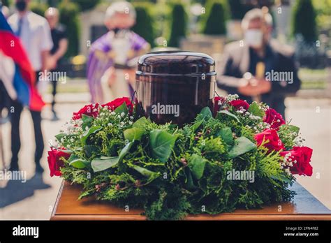 Funerary Urn With Ashes Of Dead And Flowers At Funeral Burial Urn