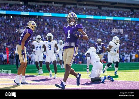 Washington Wide Receiver Rome Odunze Scores A Touchdown During An NCAA