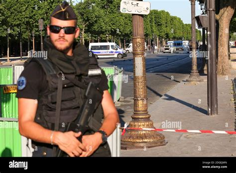 Police Officers Patrol Near The Champs Elysees Avenue On June