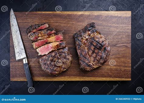 Barbecue Dry Aged Wagyu Rib Eye Beef Steaks On A Wooden Design Board