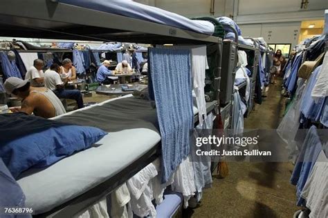 Inmates at the Mule Creek State Prison sit near their bunk beds in a ...