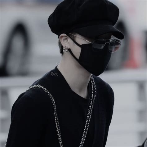 A Person Wearing A Black Hat And Sunglasses With A Chain Attached To It