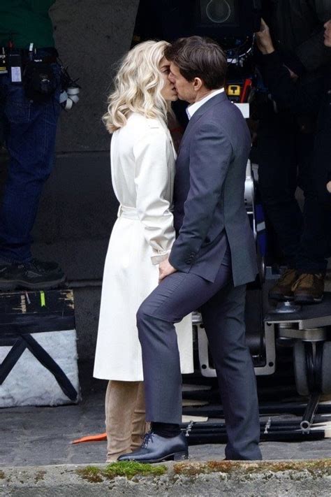 A Man In A Suit And Tie Kissing A Woman On The Set Of A Movie