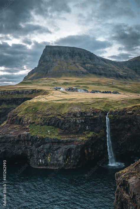 Gasadalur Village And Mulafossur Its Iconic Waterfall During Sunset In