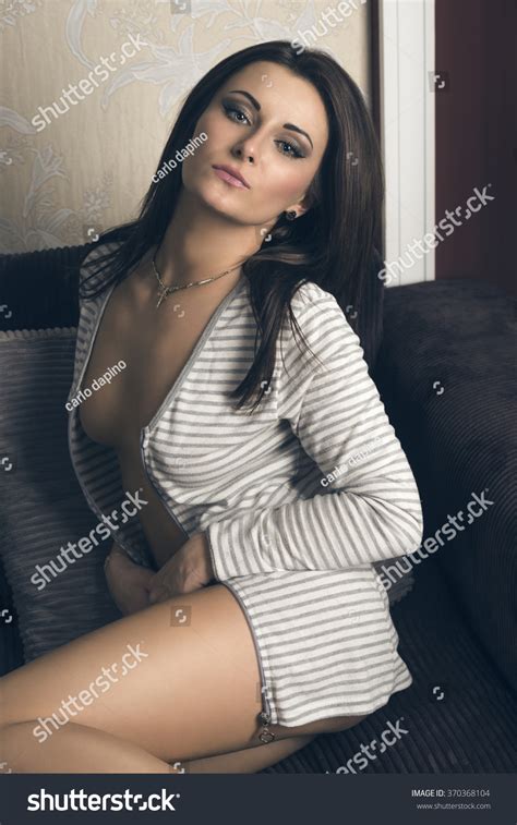 Stunning Brunette Woman Sitting On Sofa Stock Photo Shutterstock
