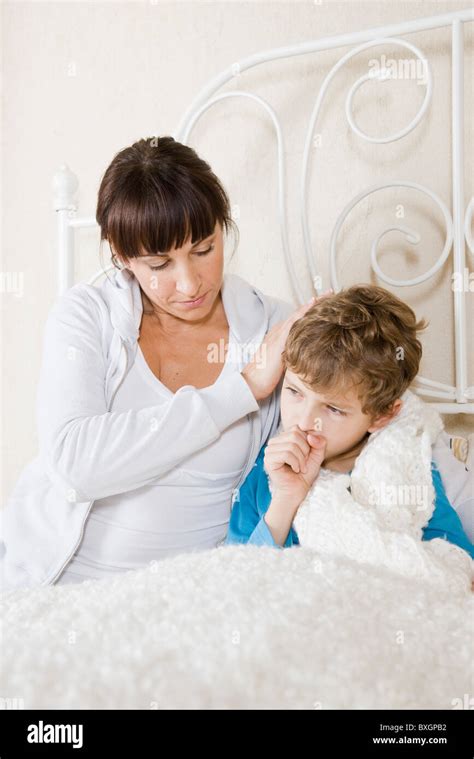 Mother Taking Care Of Sick Son Stock Photo Alamy