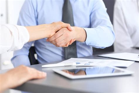 Close Up Of Business Handshake At Meeting Or Negotiation Above The Desk