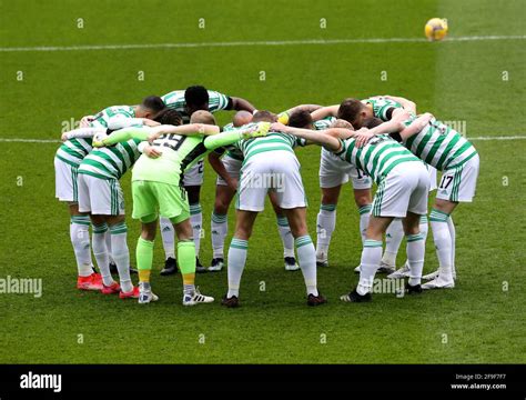 Celtic Players Huddle Together On The Pitch Ahead Of The Scottish Cup