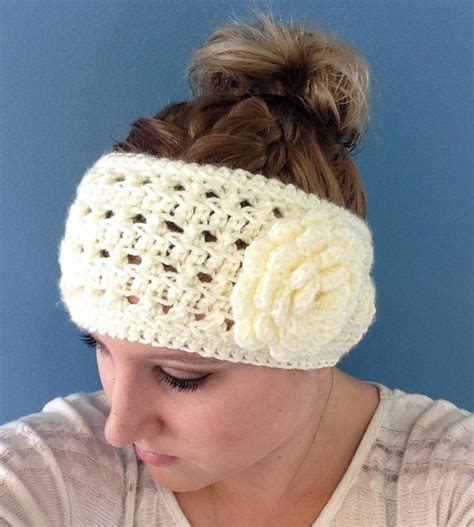 A Woman Wearing A Crocheted Headband With Flowers On Its Side