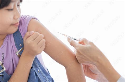 Light And Blur People Doctor Inject Vaccine To Asian Girl Deltoid