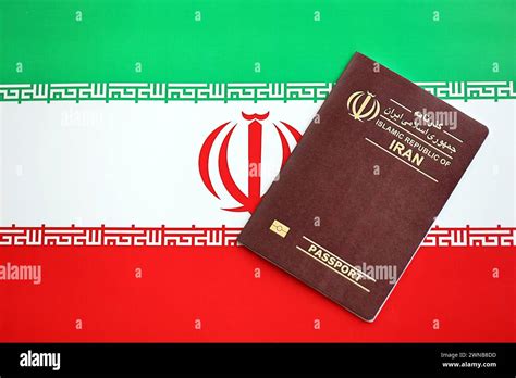 Red Islamic Republic Of Iran Passport On National Flag Background Close