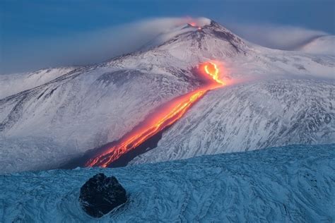 Tongue Of Fire Lava Streaming Down The Snowy Sides Of Mount Etna