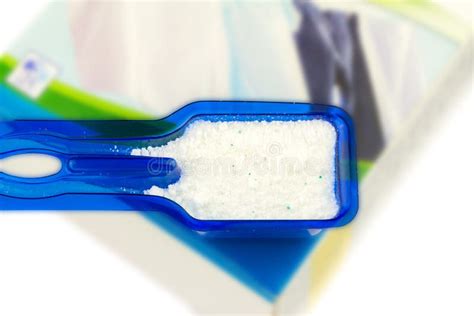 Laundry Detergent Or Washing Powder In Blue Measuring Cupisolated