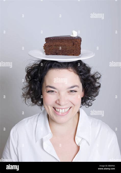 Woman With A Plate Of Cake On Her Head Stock Photo Alamy