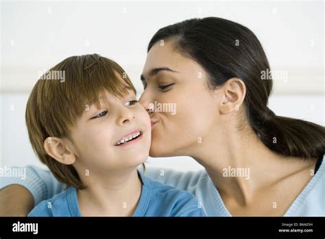 Mother Kissing Son On The Cheek Stock Photo Alamy