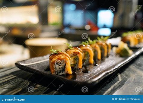 Japanese Salmon Sushi Roll Topped With Foie Gras And Chef Using