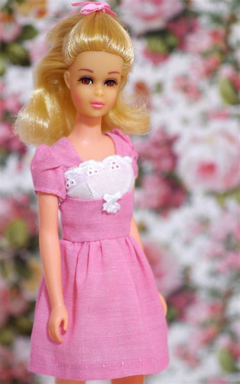 A Barbie Doll Wearing A Pink Dress And White Shoes