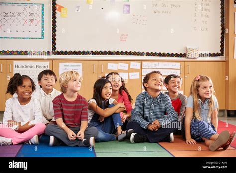 Elementary school kids sitting on classroom floor Stock Photo - Alamy