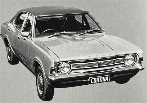 An Old Black And White Photo Of A Car With The Hood Up In The Air