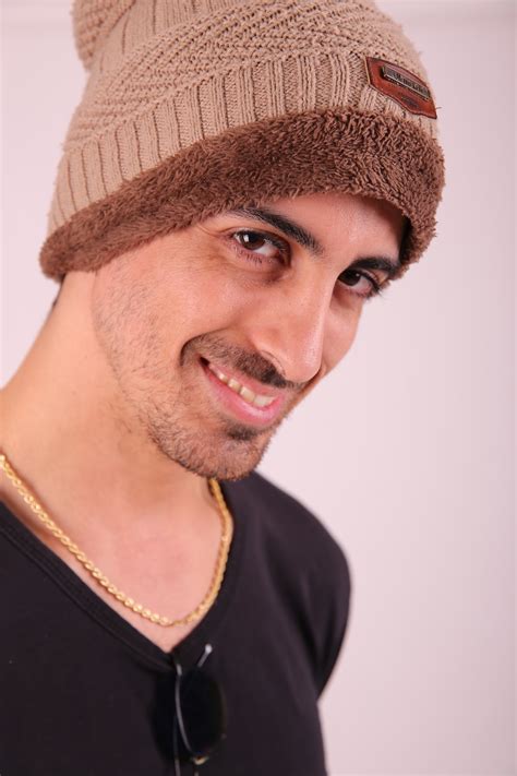 Man In Black Crew Neck Shirt Wearing Brown Knit Cap Photo Free Love