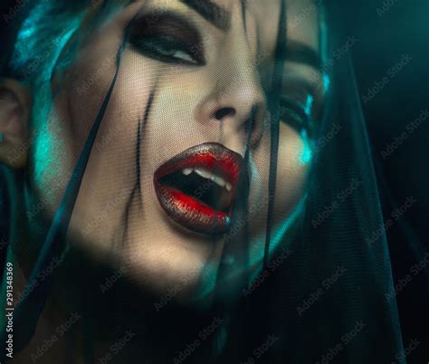 Vampire Halloween Woman portrait with black veil on a face. Beauty Sexy ...