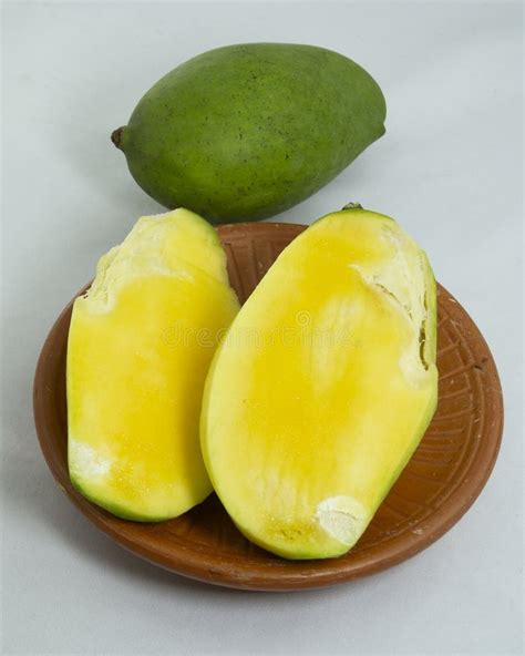 Unpeeled Green Mango And Sliced Mango On Clay Plate These Mangoes