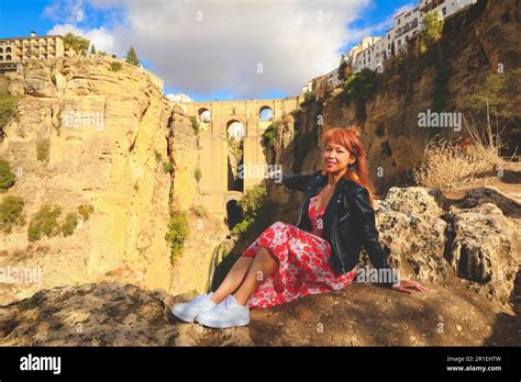 Asian Woman Travel In Ronda Spain With View Of New Bridge Puente Nuevo