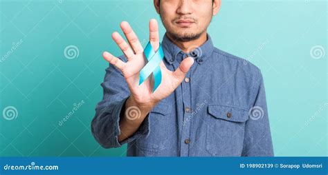 Handsome Man Posing He Holding Light Blue Ribbon For Supporting People