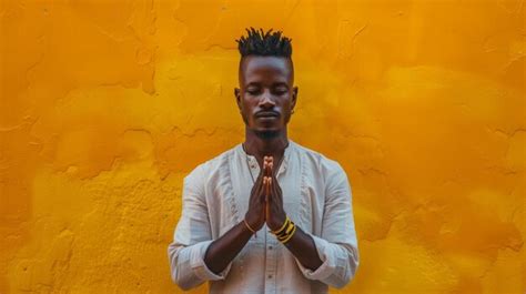 Premium Photo A Cool African Man Striking A Pose With Hands Clasped