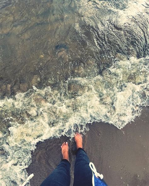 Premium Photo Low Section Of Person Standing In Sea