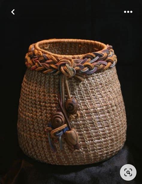 A Woven Basket Is Sitting On A Black Surface