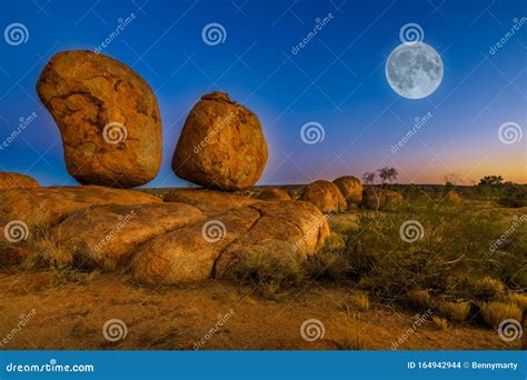 Devils Marbles full moon stock photo. Image of evening - 164942944