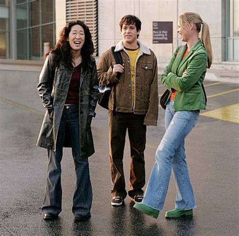 Three People Standing In The Street Laughing