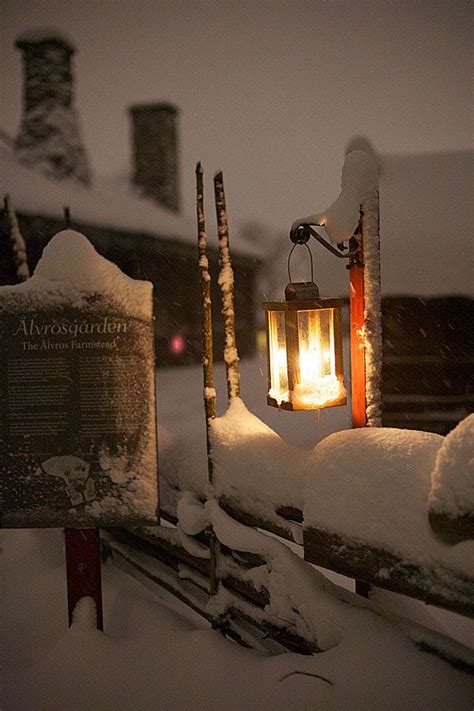 A Lantern That Is Sitting In The Snow