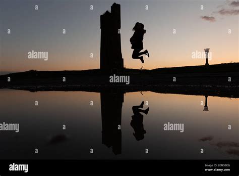 Sunset At Castle Hill Huddersfield With Reflection And Girl Jumping