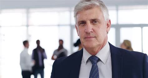Confident Serious And Mature Business Man Standing At A Convention Center Before A Conference