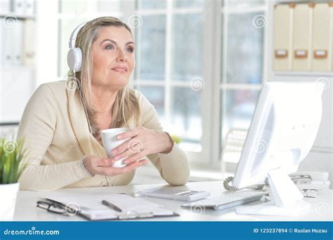 Portrait Of Mature Woman Using Computer In Office Stock Photo Image